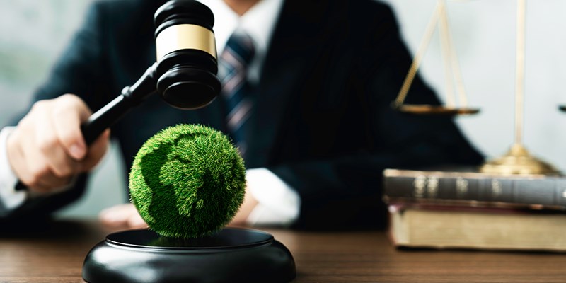 Judge hold wooden gavel with golden scale and globe for law international environmental concepts of business corporate and industry. law world environmental regulation.sustainable environment concept