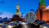 Coin in denomination of one Russian ruble against the background of the towers of the Moscow Kremlin.