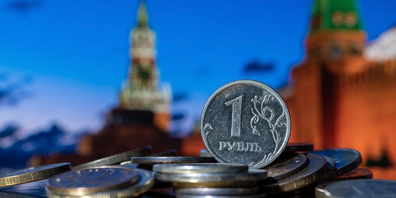 Coin in denomination of one Russian ruble against the background of the towers of the Moscow Kremlin.
