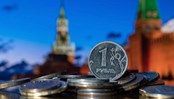 Coin in denomination of one Russian ruble against the background of the towers of the Moscow Kremlin.
