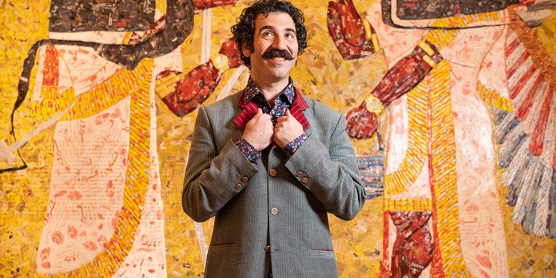 Michael Rakowitz in front of his artwork
