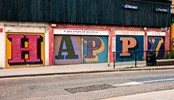 "Happy" written on a wall